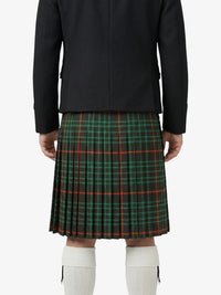Person wearing a black jacket and green plaid kilt on a white background