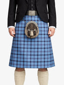 Person wearing a blue plaid kilt with a black jacket and white shirt on a white background
