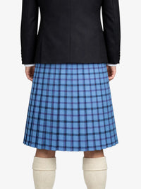 Person wearing a black jacket and blue plaid kilt on a white background