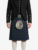 Person wearing a black jacket and tartan kilt with a silver sporran on a white background