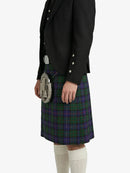 Person wearing a black jacket and tartan kilt on a white background