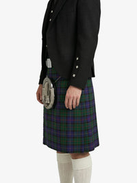 Person wearing a black jacket and tartan kilt on a white background