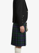 Person wearing a black jacket and plaid kilt on a white background