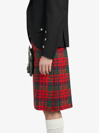 Person wearing a red tartan kilt with a black jacket on a white background