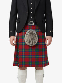 Person wearing a black jacket, red plaid kilt, and white socks on a white background