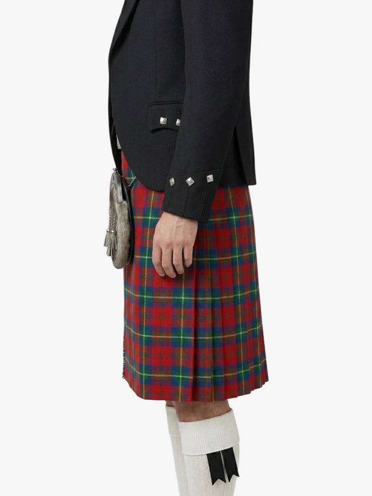 Person wearing a black jacket and red plaid kilt on a white background
