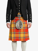 Person wearing a traditional Scottish kilt with a tartan pattern on a white background