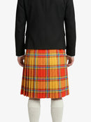 Person wearing a black jacket and colorful plaid skirt on a white background