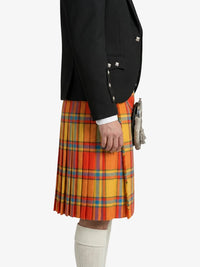 Person wearing a black jacket and a colorful plaid kilt on a white background