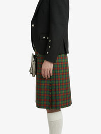 Person wearing a black blazer and red plaid kilt on a white background