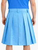 Person wearing a SKy blue pleated skirt and blue top on a white background