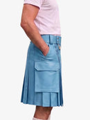 A person wearing a light blue pleated faux-leather kilt with a matching belt and silver buckle, paired with a light pink t-shirt, shown from the waist down against a plain white background.