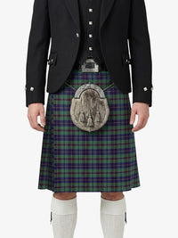 Person wearing a black jacket, green plaid kilt, and white socks on a white background