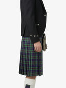 Person wearing a black jacket and green plaid kilt on a white background