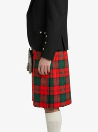Person wearing a black jacket and red plaid kilt on a white background