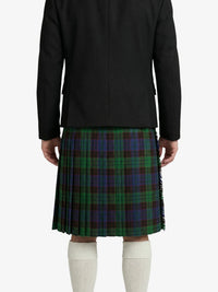 Person wearing a black jacket and green plaid kilt on a white background