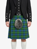 Person wearing a black jacket and green plaid kilt with a silver sporran on a white background