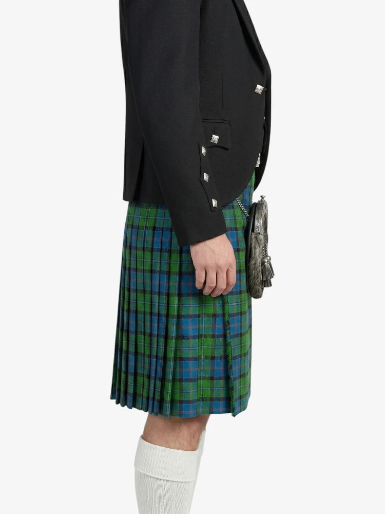 Person wearing a black jacket and green plaid kilt on a white background