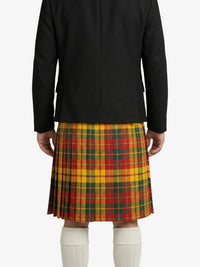 Person wearing a black jacket and a colorful plaid kilt on a white background
