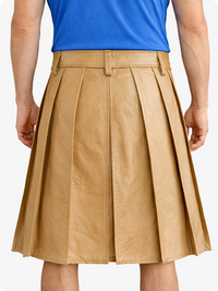Person wearing a tan pleated skirt and blue top on a white background
