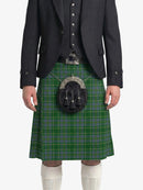Person wearing a green plaid kilt with a matching jacket on a white background
