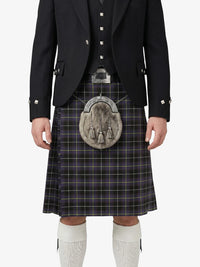 Person wearing a traditional Scottish kilt with a jacket and white socks on a white background