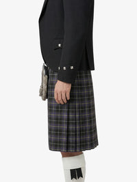 Person wearing a black jacket and plaid kilt on a white background