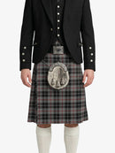 Person wearing a black jacket, vest, and plaid kilt with a silver sporran on a white background