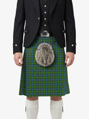 Person wearing a traditional Scottish kilt with a tartan pattern on a white background