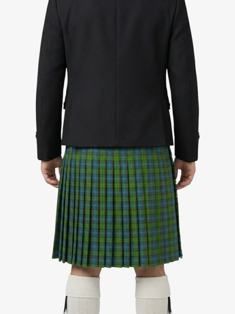 Person wearing a black jacket and green plaid kilt on a white background