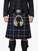Person wearing a traditional Scottish kilt with a tartan pattern on a white background