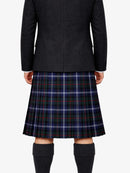 Person wearing a black coat and plaid skirt on a white background