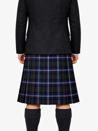 Person wearing a black coat and plaid skirt on a white background