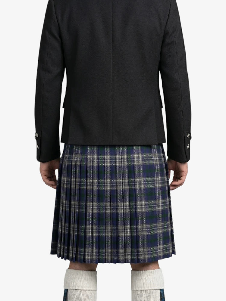Person wearing a black jacket and plaid kilt on a white background