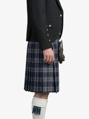Person wearing a black jacket and blue plaid kilt on a white background