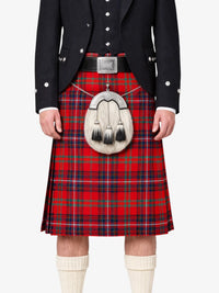 Person wearing a red tartan kilt with a black jacket and white socks on a white background