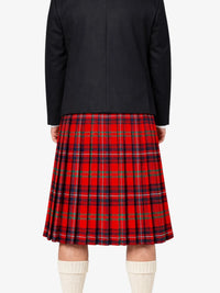 Person wearing a black jacket and red plaid kilt on a white background