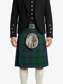 Person wearing a black jacket, green plaid kilt, and white knee-high socks on a white background