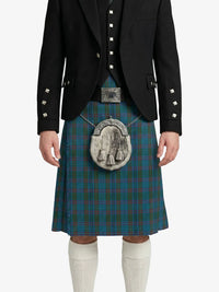 Person wearing a traditional Scottish kilt with a jacket on a white background