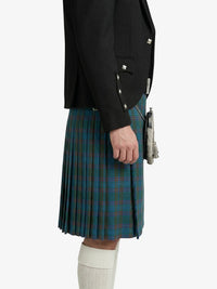 Person wearing a black jacket and green plaid kilt on a white background
