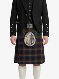 Person wearing a black jacket and tartan kilt on a white background