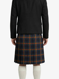 Person wearing a black jacket and plaid kilt on a white background