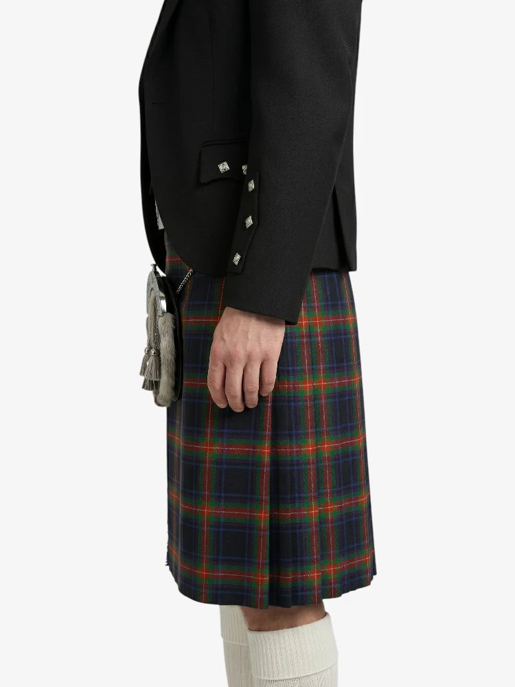 Person wearing a black jacket and plaid kilt on a white background