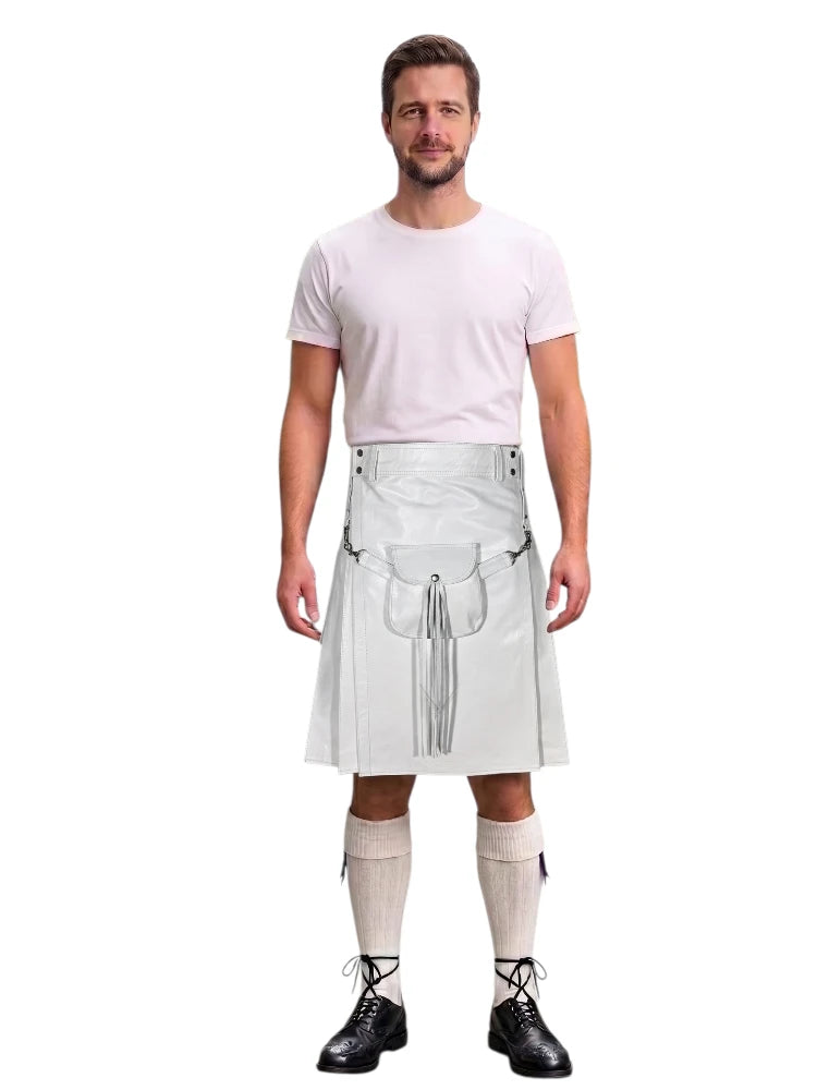 A man modeling a white faux-leather kilt costume with silver metal grommets and straps, paired with a white t-shirt, beige knee-high socks, and black shoes, against a plain white background.