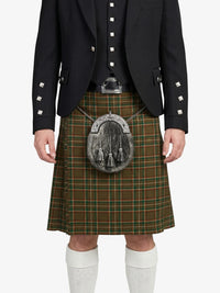 Person wearing a traditional Scottish kilt with a jacket on a white background