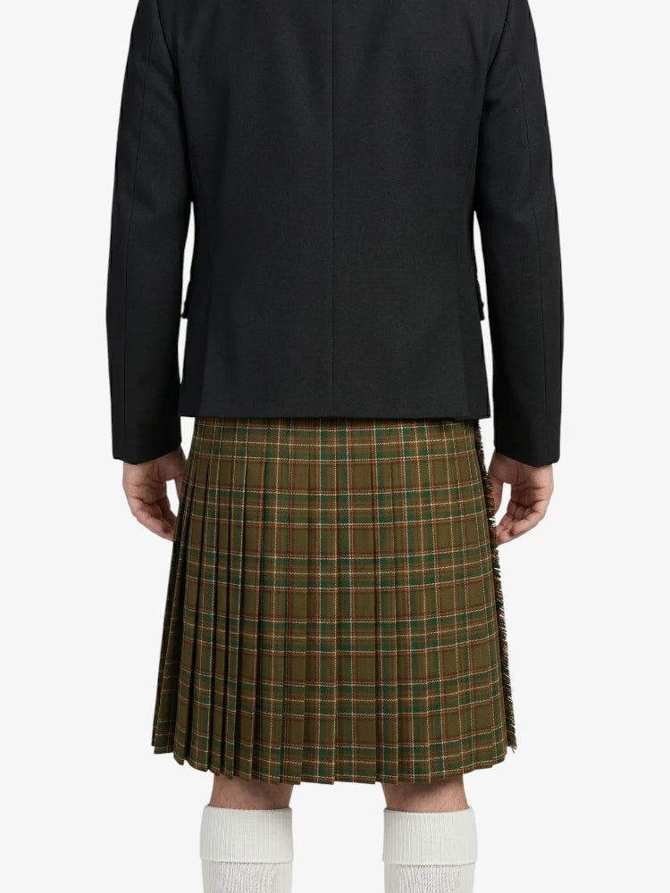 Person wearing a black jacket and green plaid kilt on a white background