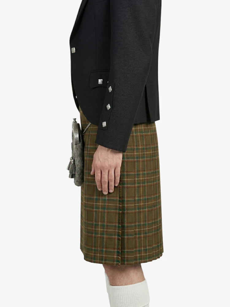 Person wearing a black jacket and green plaid kilt on a white background