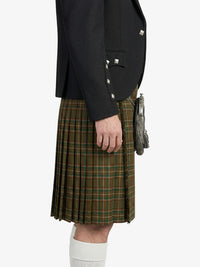 Person wearing a black jacket and green plaid kilt on a white background