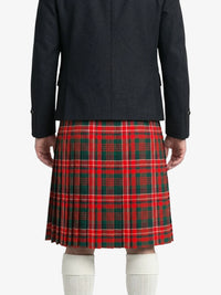 Person wearing a black coat and red plaid kilt on a white background