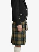 Person wearing a black jacket and plaid kilt on a white background
